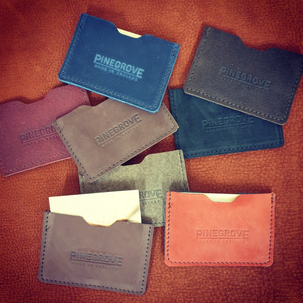 A number of Pinegrove Leather business card wallet sleeves, scattered around, with business cards